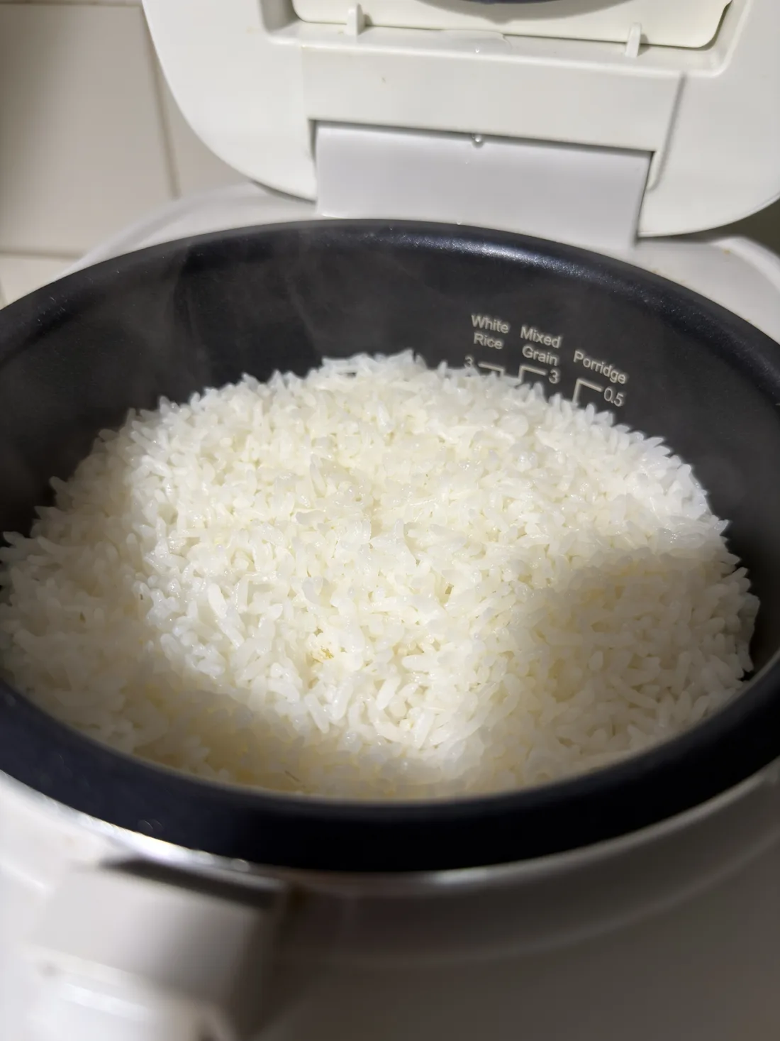 Freshly cooked Japanese short-grain rice in an open rice cooker